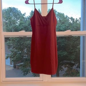 Maroon mini with crossed front. Hugs the body. Size L. Never worn.